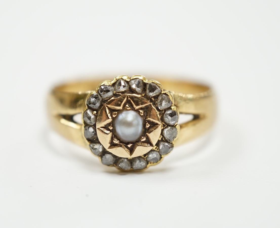 An Edwardian 18ct gold, rose cut diamond and split pearl cluster set ring, size O, gross weight 3.2 grams.